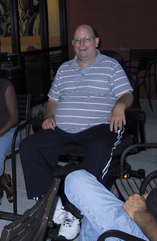 Tim Kimball dressed casually, seated outside at Starbucks gathering